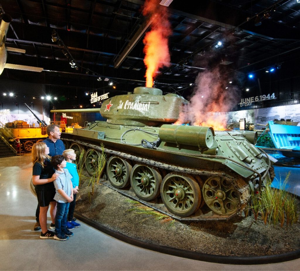 Family viewing a tank exhibit at the American Heritage Museum